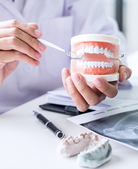 Dentist pointing at a smile model