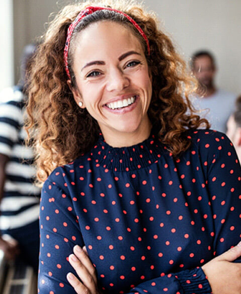 smiling young woman with people behind her