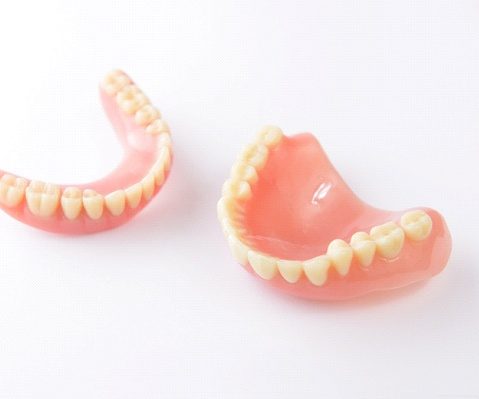 Closeup of full dentures in Fayetteville on white background