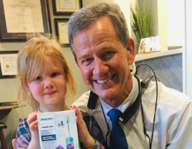 Doctor Lee and young dental patient smiling together