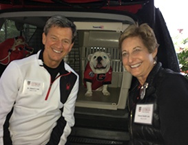 Doctor Lee and his wife with a dog in a carrier