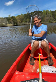 Doctor Lee in a boat holding a net