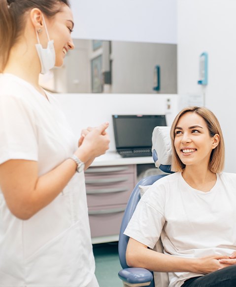 Woman smiling during family dentistry checkup and teeth cleaning visit