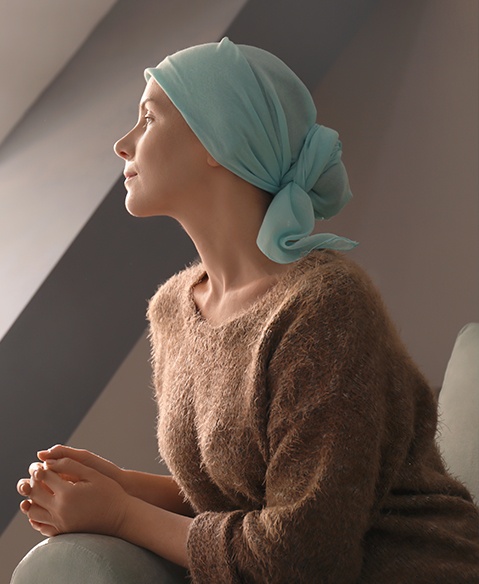 Female cancer patient wearing scarf over her head