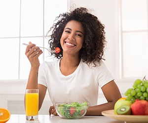 Woman eating salad in Fayetteville