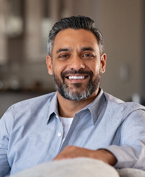 man smiling and sitting on the couch