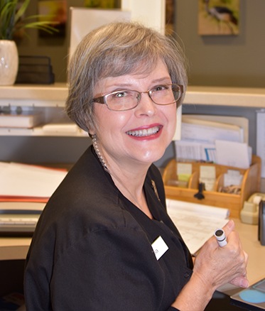 Smiling Fayetteville dental team member at reception desk