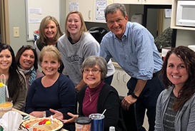 Fayetteville dentist and dental team members smiling together in a kitchen
