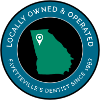 Icon of Georgia with text saying locally owned and operated Fayetteville's dentist since 1983