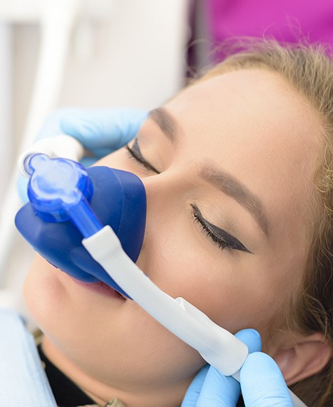 Woman with nitrous oxide sedation dentistry mask in place