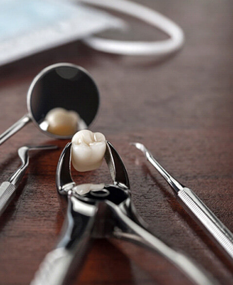 dental instruments with extracted tooth on a table