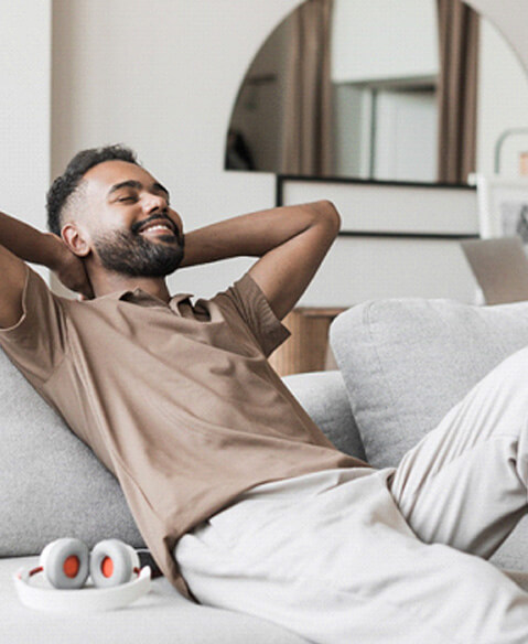 guy happily resting on the couch