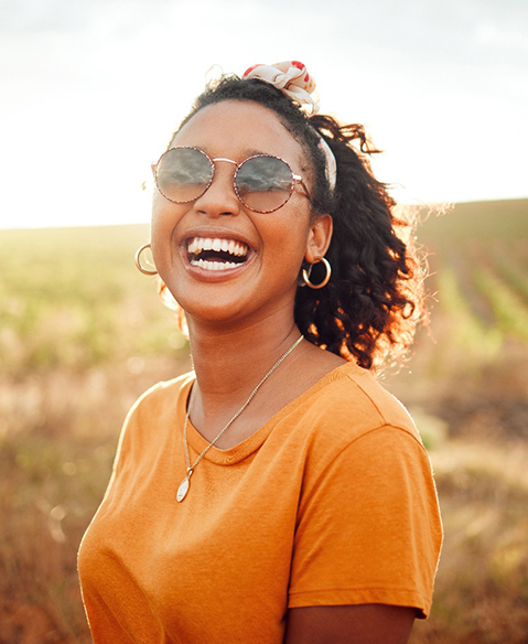 smiling woman who understands the cost of veneers