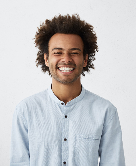 man wearing a button-up shirt smiling