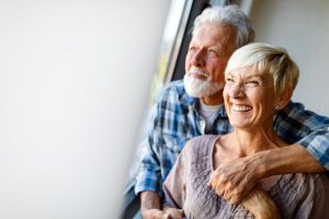 couple smiling after understanding the types of dental implants