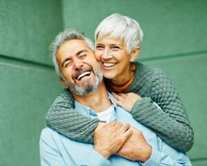 smiling seniors hugging